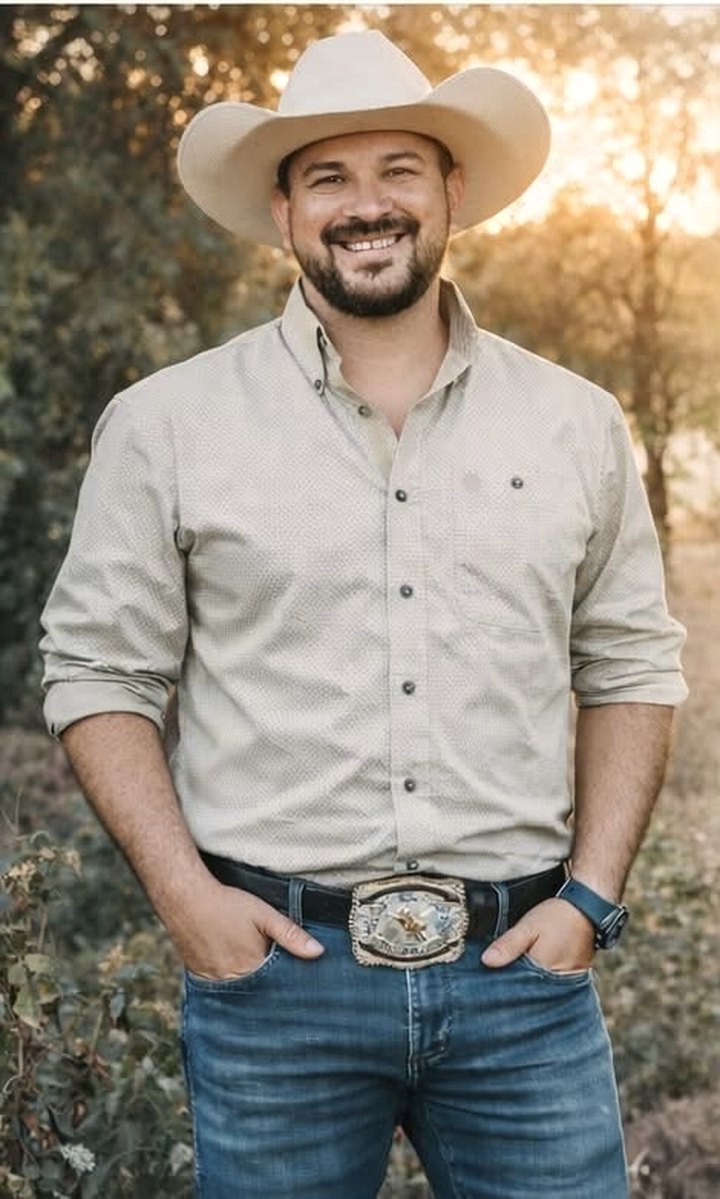 Isidro Martinez Jr., founder of AgCommand Technologies, in a Central Valley orchard at golden hour